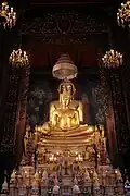 The statues of Phra Phuttha Chinnasi (front) and Phra Suwannakhet (back) in the main shrine hall. The ashes of King Rama IX are kept under the base of the statues