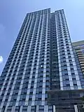 1 North 4th Place, a high-rise clad in blue glass, viewed from street level