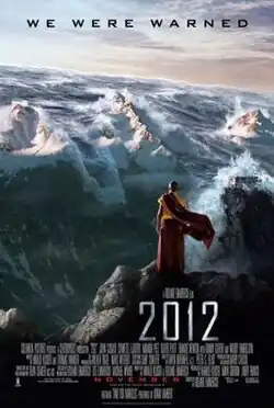 Film poster showing a Nepalese monk on a mountain watching as tsumani waves coming over the Himmalyan mountains, with the film's credits, title and release date in the bottom and tagline above reading. "We were warned."