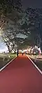 Visitors promenading on Clark Parade Grounds' running track at night.