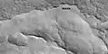 Close view of mantle near a layered feature, as seen by HiRISE under HiWish program Mantle is deposited when the climate changes. It is composed of ice-coated dust.