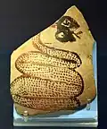 Shard of pottery decorated with a snake sticking out its tongue. Tell Arpachiyah, Iraq. Halaf period (6000–5000 BC). British Museum.