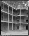 A view toward the southwest corner of the interior, showing the octagonal wooden structure atop the southwest circular staircase.