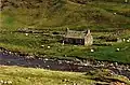 An aerial ropeslide spanning the river, approximately halfway along its course, provides a resident easy access to their cottage (2000)