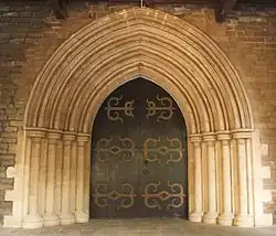 Buff-coloured basalt and limestone doorway to the CNI Afghan Church[191]