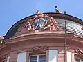 Coat of arms of the Ostein dynasty, framing the central risalit on the facade