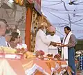 Arvind Singh Mewar presents the Maharana Sajjan Singh Award to Gopal Prasad Sharma.