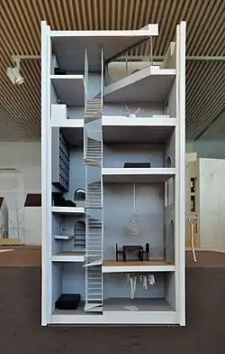view of multilevel model of a house with central staircase and furnishings