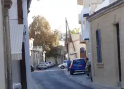 Agioi Omologites Avenue, traditional thoroughfare of the old village. Note the narrowness of the street and traditional design of the houses