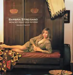 The singer's appears spread out on a long chair with her left hand arched in order to support herself.