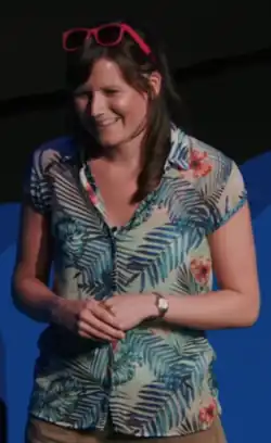 Smethurst smiling and presenting with sunglasses on top of her head