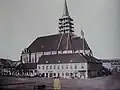 Church with adjacent buildings, new tower under construction (1850)
