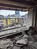 Destroyed room wall looking over street