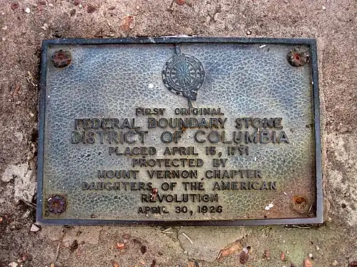 Plaque placed in the sea wall next marking the south cornerstone.