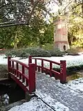 Asian style bridge with the water tower in the background.