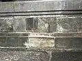 A bas-relief of Dharmacakra and Crouching Deers beneath the plinth inside the temple
