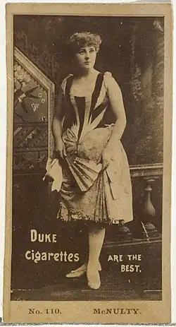 Woman standing holding a fan