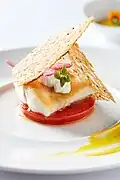 Pan roasted wild Norwegian halibut, tomato confit, feta, rosemary bread crisp, and aioli.