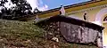 An old grave next to the mausoleum which has a "dapur" (cenotaph) atop it.