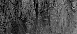 Gully aprons as seen by HiRISE under HiWish program This image was named HiRISE Picture of the Day for June 25, 2024.