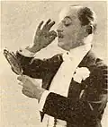 Smirking Conceit (Robert Schable) with his ever-present mirror.[3]