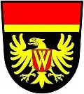 a fillet and a chief—Sable; an eagle displayed or, charged on the breast with an escutcheon gules, thereupon two chevrons couped interlaced inverted or; a chief gules filleted [supported by a fillet] or—Wing Riders of South Africa