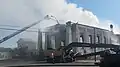 First Methodist burns for the eleventh hour as fire crews from Marshall and Longview fight it as an excavator is brought in to demolish the western wall.