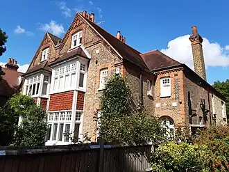 Among the first houses of Bedford Park was this one with paired gables on The Avenue by Coe & Robinson, 1876