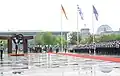 Order of precedence at the state visit of Greek prime minister Antonis Samaras in Berlin (24 August 2012): The Greek flag takes the first order of precedence, followed by the German flag on the right (seen on the left when facing the building) and the European flag in third order, on the left.