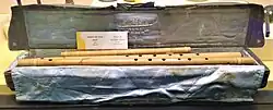Flutes kept in a bag with name of the player embroidered on the bag