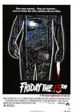A film poster showing an image of group of teenagers standing outside a cabin, outlined by a silhouette figure holding a knife