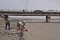 Digging for jade under the G315 Highway bridge over the Hotan River