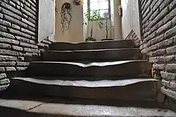 Only the upper part retains stone steps.