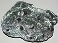 Garnet porphyroblasts in schist featuring the deflection of the foliation around their space