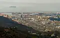 The mouth of the Polcevera; in the background is the Port of Genoa