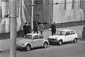 Japanese officials walking with Dutch detectives