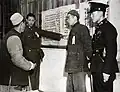 Government officials explaining to people the rules of the voting process