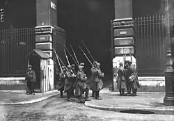 Platoon of eleven soldiers guarding the entrance to the building.