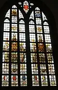 Stained glass window in the church donated by A.J. Enschedé with Laurens Janszoon Coster on the left and a typesetter's workshop on the right.