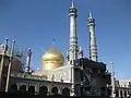 The mosque minarets, with the adjacent shrine's golden dome