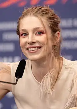 Schafer smiling while speaking into a microphone