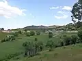 Village surrounded by lush greenery as seen from the hillside