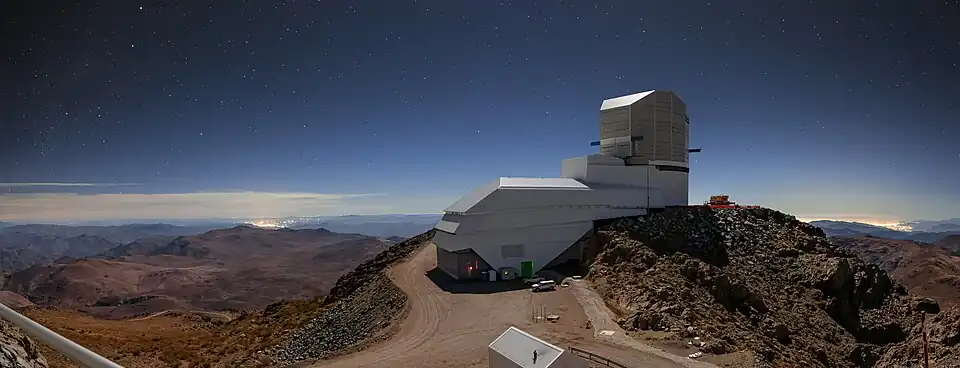 Night light with sky brightening due to the artificial light that can be seen as clusters of bright lights on the horizon