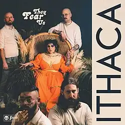 A woman wearing a crown and orange dress sitting on a throne, surrounded by four men in white and grey attire. The words "They Fear Us" towards the top left, and "Ithaca" on the right.