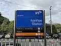 The southern side station entrance signage, August 2024