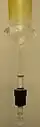 A J. Young NMR tube attached to an adapter with a female 24/40 joint already greased. Note the hole resulting from the T-bore in the side of the PTFE plug.