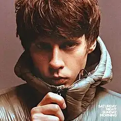 A photo of Bugg pulling up the zipper to a coat