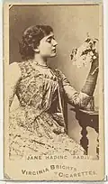 Woman sitting holding flowers in left hand