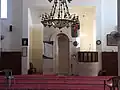The prayer hall of the modern mosque, with mihrab and minbar visible