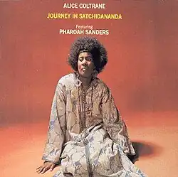 Coltrane seated on the floor